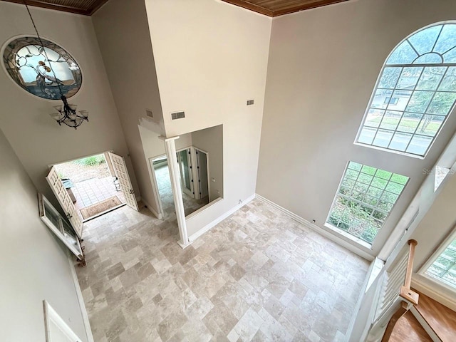 16006 Armistead Ln, Odessa, FL 33556 - foyer entrance with a towering ceiling, stone finish flooring, and crown molding
