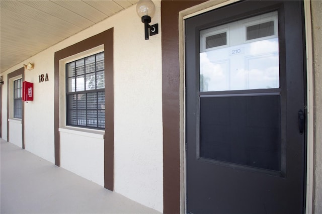 2400 Winding Creek Blvd Unit Bldg18A # 210, Clearwater, FL 33761 - view of exterior entry with a porch and stucco siding