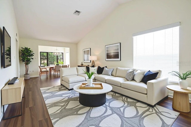 2400 Winding Creek Blvd Unit Bldg18A # 210, Clearwater, FL 33761 - living room with dark wood-type flooring, high vaulted ceiling, and a chandelier