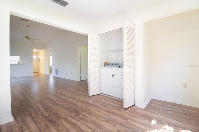 2400 Winding Creek Blvd Unit Bldg18A # 210, Clearwater, FL 33761 - empty room featuring washer and dryer, a ceiling fan, wood finished floors, and vaulted ceiling