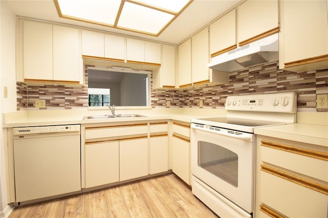 2400 Winding Creek Blvd Unit Bldg18A # 210, Clearwater, FL 33761 - kitchen featuring white appliances, under cabinet range hood, tasteful backsplash, and light countertops