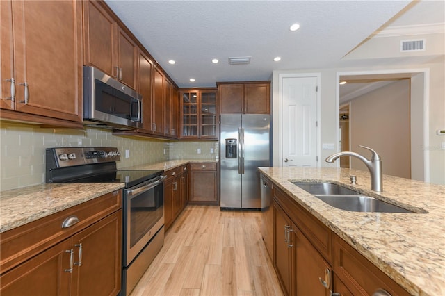 10520 Boardwalk Loop Unit 202, Bradenton, FL 34202 - kitchen with stainless steel appliances, light wood finished floors, light stone counters, tasteful backsplash, and recessed lighting