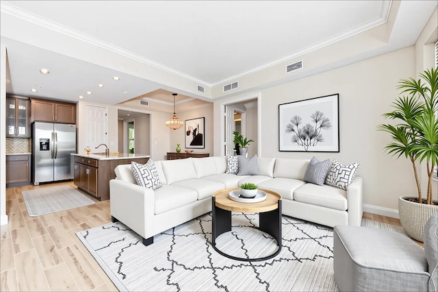 10520 Boardwalk Loop Unit 202, Bradenton, FL 34202 - living area featuring light wood finished floors, recessed lighting, and crown molding