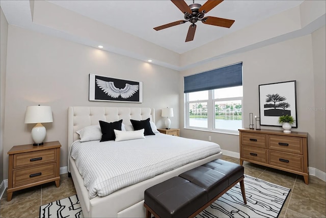 10520 Boardwalk Loop Unit 202, Bradenton, FL 34202 - bedroom featuring light tile patterned floors, a tray ceiling, recessed lighting, and a ceiling fan