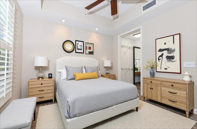 10520 Boardwalk Loop Unit 202, Bradenton, FL 34202 - bedroom featuring wood finished floors, recessed lighting, a tray ceiling, and a ceiling fan