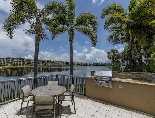 10520 Boardwalk Loop Unit 202, Bradenton, FL 34202 - view of patio / terrace featuring an outdoor kitchen, a water view, and outdoor dining area