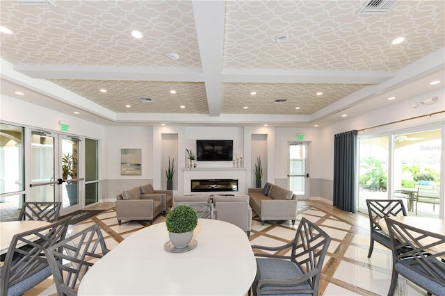 10520 Boardwalk Loop Unit 202, Bradenton, FL 34202 - dining area featuring french doors, recessed lighting, a glass covered fireplace, beam ceiling, and coffered ceiling
