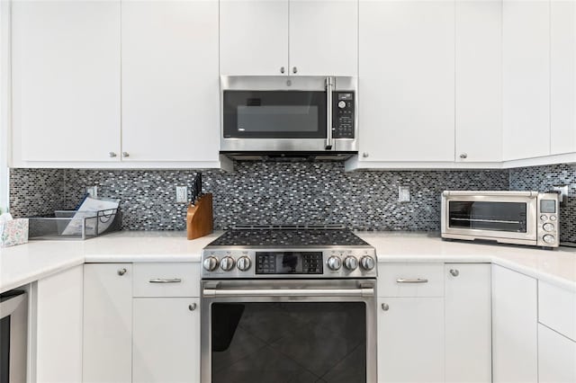 706 Bayway Blvd Unit 503, Clearwater, FL 33767 - kitchen with appliances with stainless steel finishes, light countertops, and white cabinets