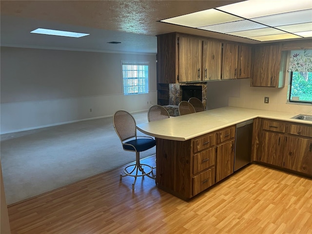 1813 Laurel Oak Dr, Valrico, FL 33596 - kitchen featuring dishwasher, a kitchen bar, light countertops, a peninsula, and light wood-style floors