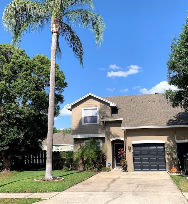5139 Corvette Dr, Tampa, FL 33624 - traditional-style house with a garage, driveway, stucco siding, and a shingled roof