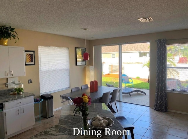 5139 Corvette Dr, Tampa, FL 33624 - dining space featuring light tile patterned floors and a textured ceiling