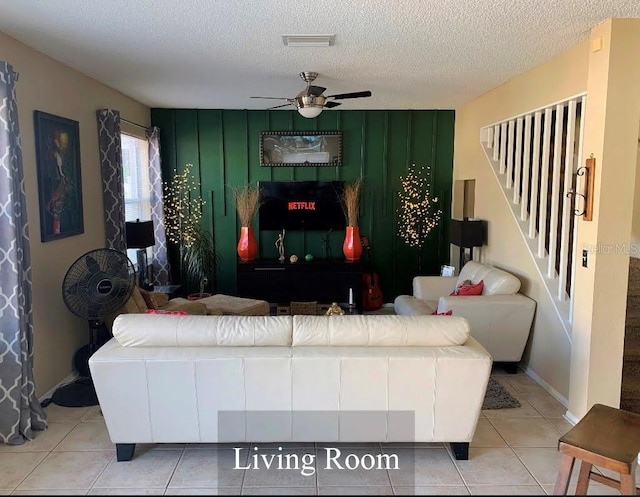5139 Corvette Dr, Tampa, FL 33624 - tiled living room with a ceiling fan, a textured ceiling, and stairway