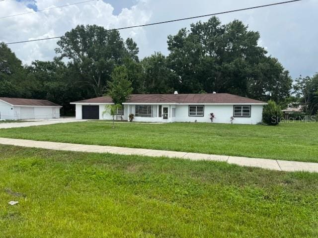 17048 State Road 54, Lutz, FL 33558 - single story home featuring a front yard, concrete driveway, and a garage