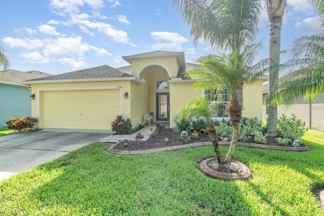 13194 Royal Pines Ave, Riverview, FL 33579 - view of front facade with stucco siding, an attached garage, driveway, and a front yard