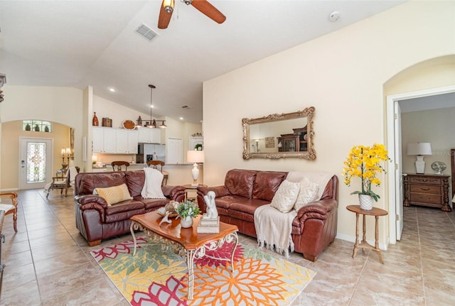 13194 Royal Pines Ave, Riverview, FL 33579 - living area featuring arched walkways, vaulted ceiling, ceiling fan, and light tile patterned flooring