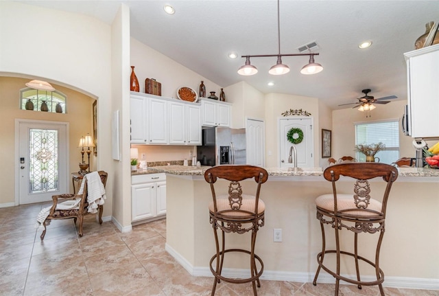 13194 Royal Pines Ave, Riverview, FL 33579 - kitchen with appliances with stainless steel finishes, a kitchen breakfast bar, a ceiling fan, white cabinetry, and recessed lighting