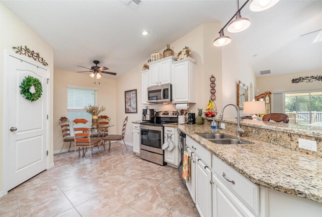 13194 Royal Pines Ave, Riverview, FL 33579 - kitchen with stainless steel appliances, a ceiling fan, white cabinetry, light stone counters, and a peninsula