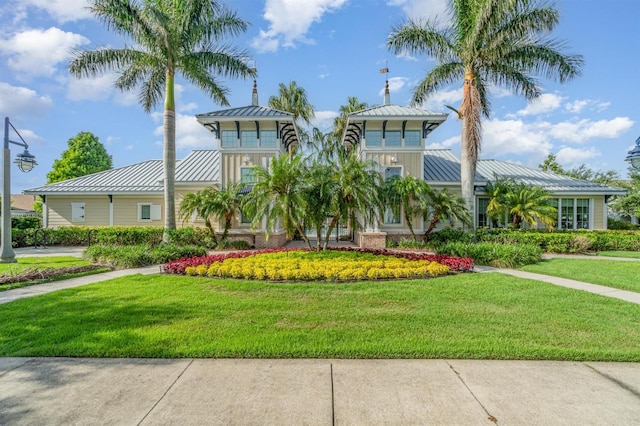 13194 Royal Pines Ave, Riverview, FL 33579 - view of front facade with a standing seam roof, a metal roof, and a front yard