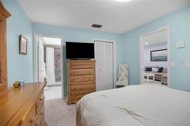 1701 Pinehurst Rd Unit 33E, Dunedin, FL 34698 - carpeted bedroom featuring a closet and ensuite bath