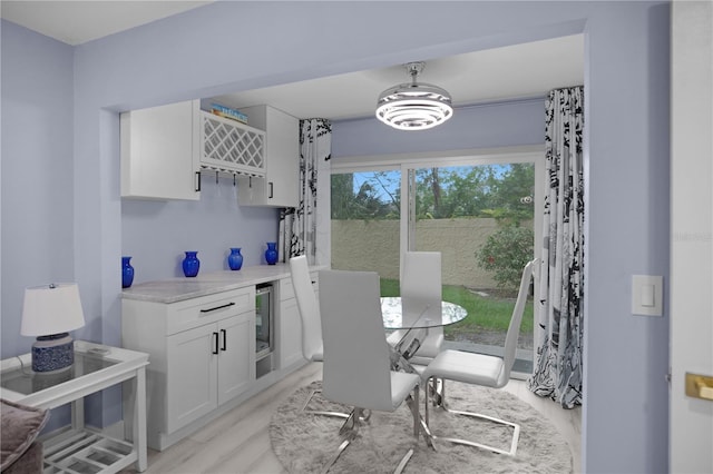 1701 Pinehurst Rd Unit 33E, Dunedin, FL 34698 - dining space featuring a dry bar and light wood-style floors