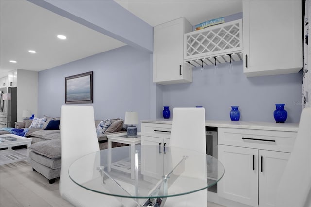 1701 Pinehurst Rd Unit 33E, Dunedin, FL 34698 - dining room featuring recessed lighting, a bar, and light wood-style flooring