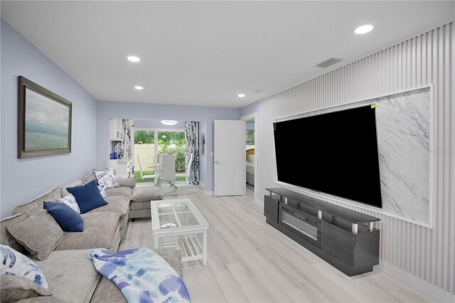 1701 Pinehurst Rd Unit 33E, Dunedin, FL 34698 - living room with recessed lighting, wood finished floors, and an accent wall