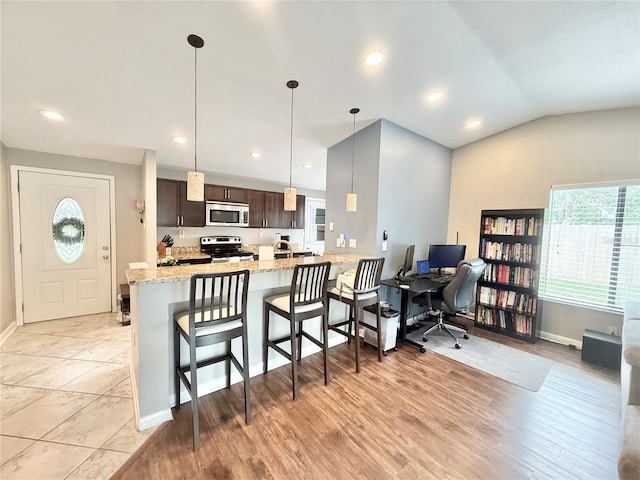 630 Timber Bay Cir W, Oldsmar, FL 34677 - kitchen featuring stainless steel microwave, range with electric cooktop, dark brown cabinetry, a kitchen breakfast bar, and an office area