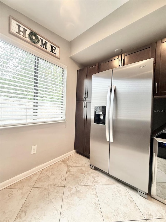 630 Timber Bay Cir W, Oldsmar, FL 34677 - kitchen with stainless steel fridge, dark brown cabinetry, light tile patterned floors, and wine cooler