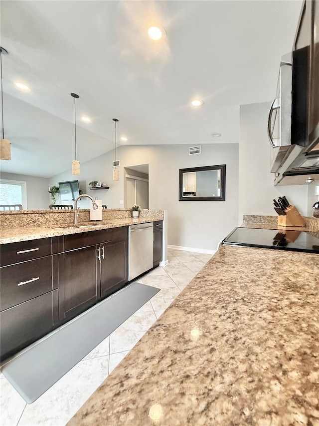630 Timber Bay Cir W, Oldsmar, FL 34677 - kitchen featuring stainless steel appliances, vaulted ceiling, dark brown cabinetry, light stone counters, and hanging light fixtures