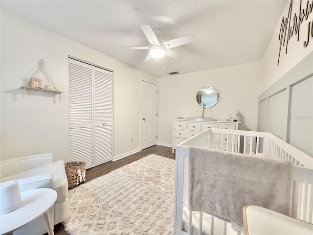 630 Timber Bay Cir W, Oldsmar, FL 34677 - bedroom featuring dark wood-type flooring, a closet, a nursery area, and ceiling fan