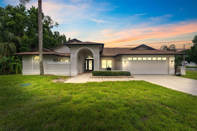 3509 Country Creek Ln, Valrico, FL 33596 - view of front of home with a front yard, a garage, concrete driveway, and stucco siding