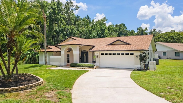 3509 Country Creek Ln, Valrico, FL 33596 - view of front of home with concrete driveway, a garage, a front lawn, and roof with shingles