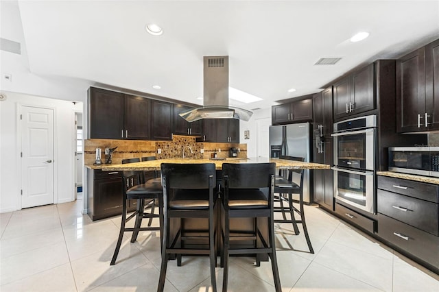 3509 Country Creek Ln, Valrico, FL 33596 - kitchen with stainless steel appliances, island exhaust hood, backsplash, light tile patterned floors, and recessed lighting