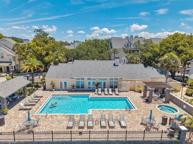 3301 Haviland Ct Unit 301, Palm Harbor, FL 34684 - community pool featuring a patio area, a pergola, and a community hot tub
