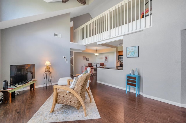 3301 Haviland Ct Unit 301, Palm Harbor, FL 34684 - living area featuring wood finished floors and high vaulted ceiling