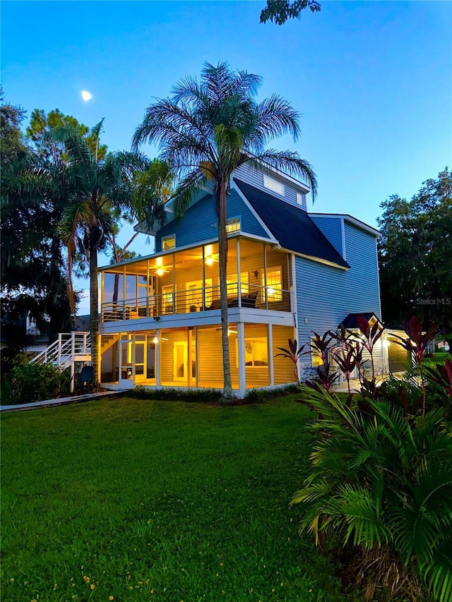 20111 County Line Rd, Lutz, FL 33558 - rear view of property with a lawn, a balcony, and a sunroom