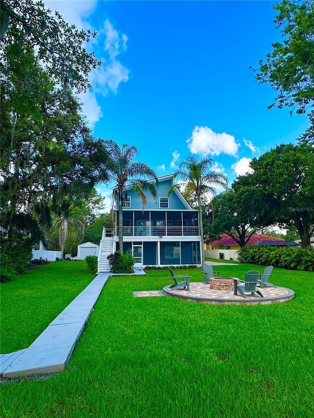 20111 County Line Rd, Lutz, FL 33558 - rear view of house with a fire pit, stairway, a yard, a patio, and a balcony