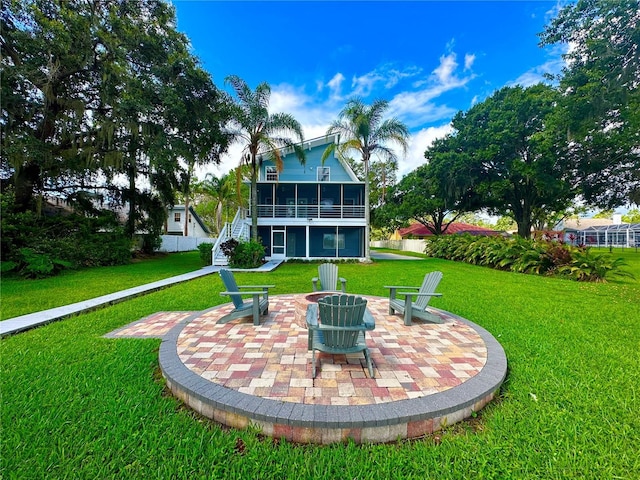 20111 County Line Rd, Lutz, FL 33558 - back of house featuring a sunroom, a patio, a fire pit, a lawn, and stairway