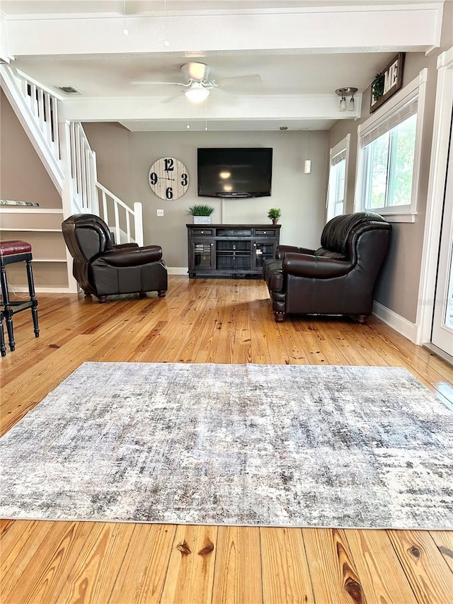 20111 County Line Rd, Lutz, FL 33558 - living area with wood finished floors, stairway, beamed ceiling, and ceiling fan