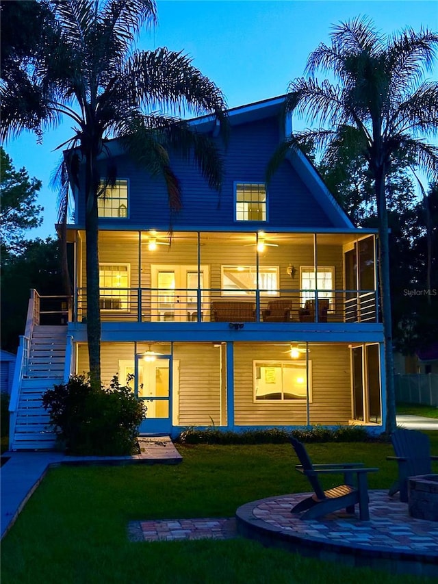 20111 County Line Rd, Lutz, FL 33558 - rear view of house featuring stairway, a balcony, a yard, a patio area, and a fire pit