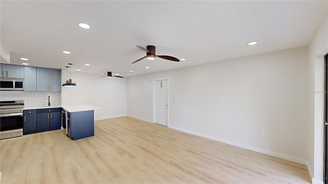 3232 Lake Pine Way E Unit A2, Tarpon Springs, FL 34688 - kitchen featuring stainless steel electric range oven, white microwave, ceiling fan, light countertops, and tasteful backsplash