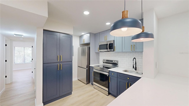 3232 Lake Pine Way E Unit A2, Tarpon Springs, FL 34688 - kitchen featuring stainless steel appliances, decorative backsplash, light wood-style floors, light countertops, and decorative light fixtures