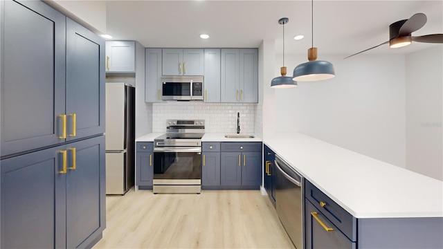 3232 Lake Pine Way E Unit A2, Tarpon Springs, FL 34688 - kitchen featuring appliances with stainless steel finishes, a peninsula, light wood-style flooring, light countertops, and recessed lighting
