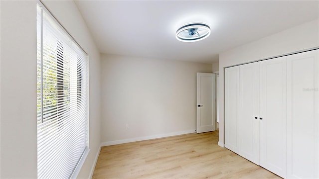 3232 Lake Pine Way E Unit A2, Tarpon Springs, FL 34688 - unfurnished bedroom featuring light wood-type flooring and a closet