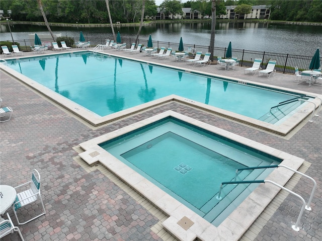 3232 Lake Pine Way E Unit A2, Tarpon Springs, FL 34688 - community pool featuring a patio area and a water view