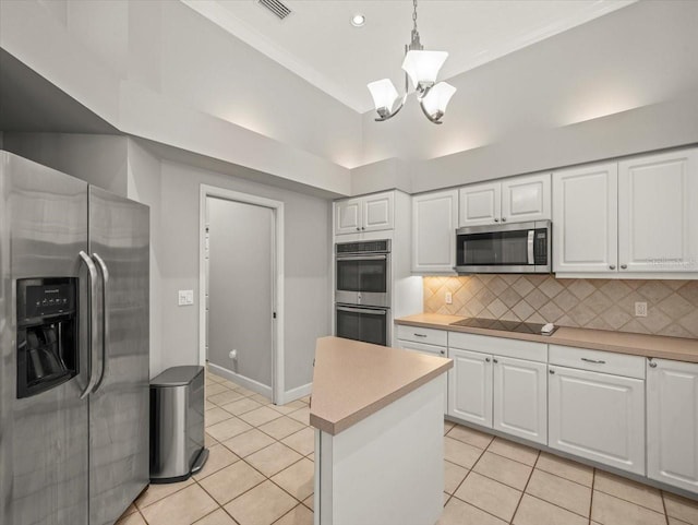 6905 Arabian Rd, Odessa, FL 33556 - kitchen featuring stainless steel appliances, light tile patterned flooring, a chandelier, white cabinetry, and backsplash