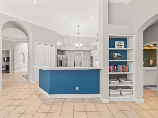 6905 Arabian Rd, Odessa, FL 33556 - kitchen with appliances with stainless steel finishes, built in shelves, light tile patterned floors, white cabinets, and tile countertops