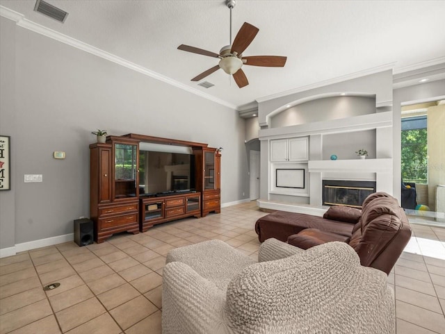 6905 Arabian Rd, Odessa, FL 33556 - living room with light tile patterned floors, ornamental molding, ceiling fan, and a glass covered fireplace