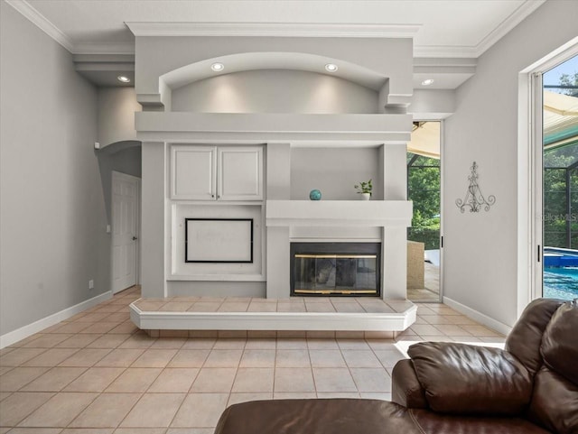 6905 Arabian Rd, Odessa, FL 33556 - living area with light tile patterned floors, crown molding, a glass covered fireplace, and arched walkways