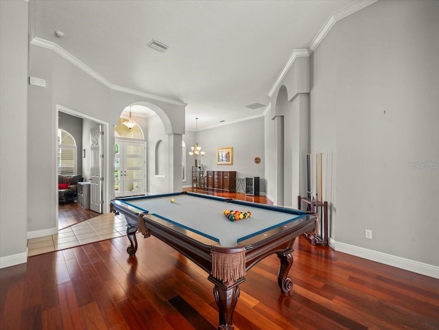 6905 Arabian Rd, Odessa, FL 33556 - playroom with arched walkways, wood finished floors, billiards, ornamental molding, and a chandelier